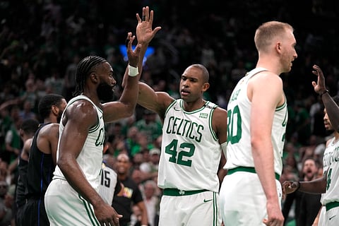 Jaylen Brown, left, celebrates with teammates